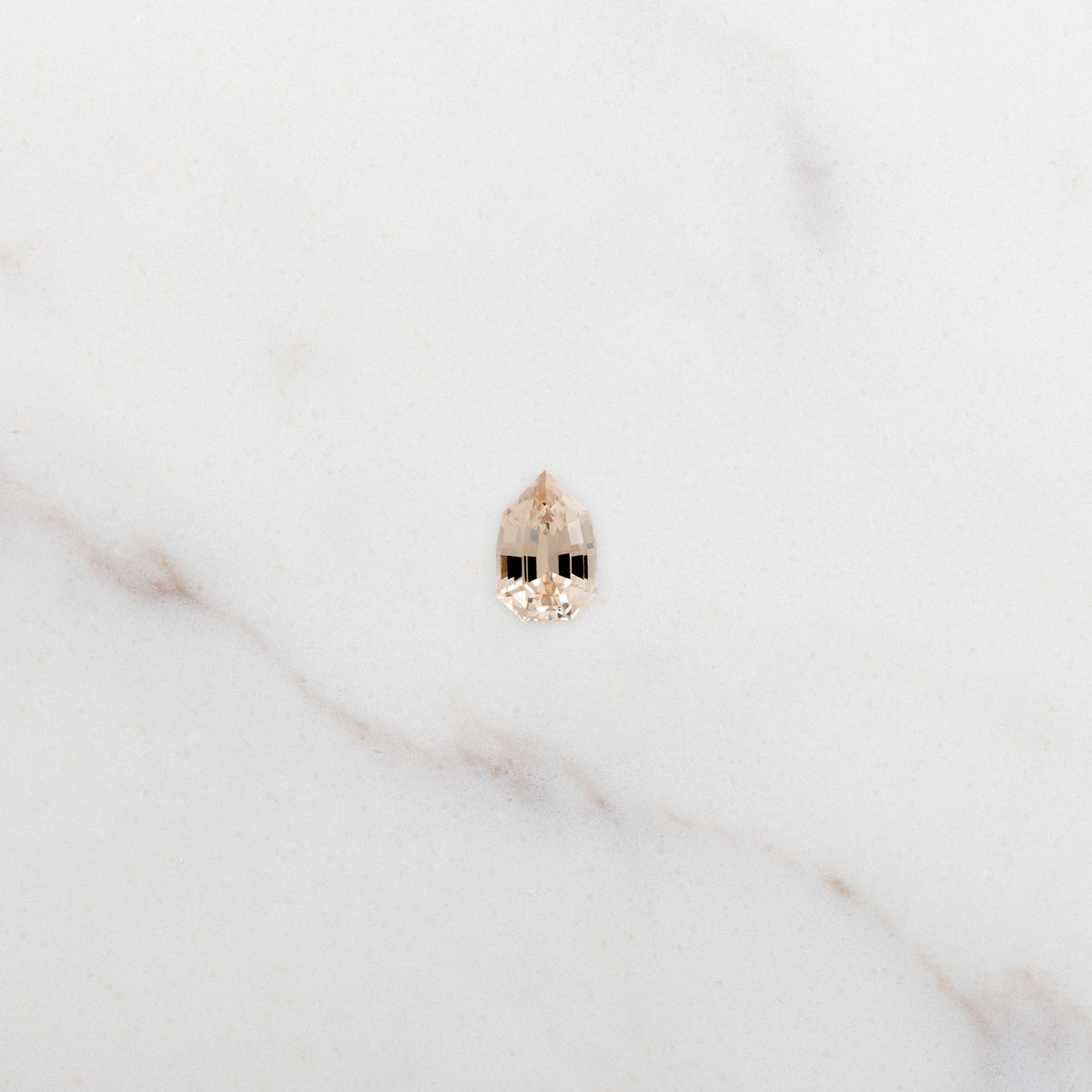 0.73ct Fancy Shield Cut Pale Apricot Natural Sapphire